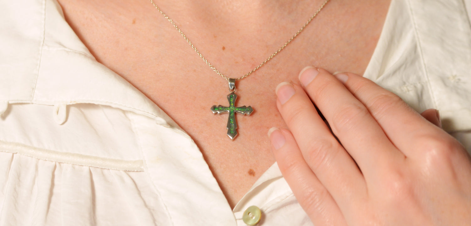 Opals & Ashes Decorative Cross Unisex Memorial Pendant Silver. Modelled on female. Ashes blended with Spring Green Opals.