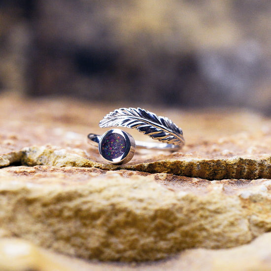 Opals & Ashes Angel Feather Memorial Ring. Sterling Silver & Lavender opals blended with our customers loved one’s ashes. Photographed on rock