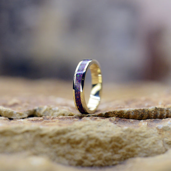 Opals & Ashes Circle Memorial Ring. Yellow gold & Lavender opals blended with our customers loved one’s ashes. Photographed on rock