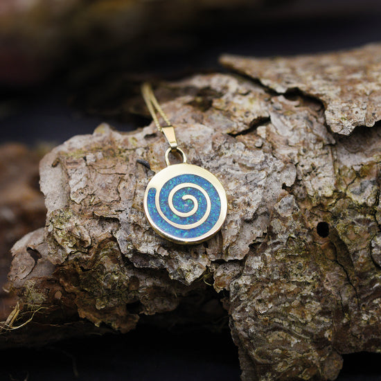 Opals & Ashes Spiral memorial Pendant. Yellow gold filled with pacific blue opals blended with our customers loved one’s ashes