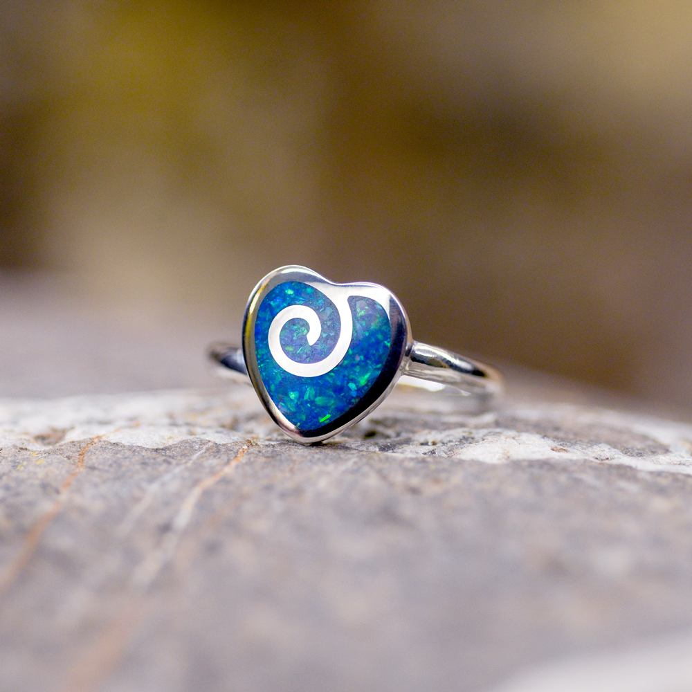 Opals & Ashes Spiral Heart Memorial Ring Silver. Ashes blended with Pacific Blue Opals. Photographed on Rock.