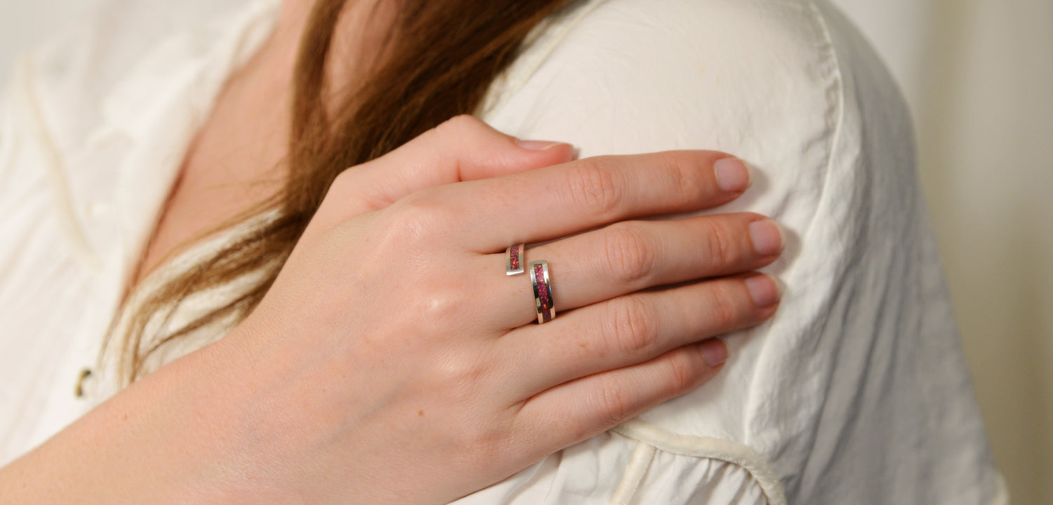 Opals & Ashes Spiral Memorial Ring Silver. Modelled on female hand. Ashes blended with lavender Opals.