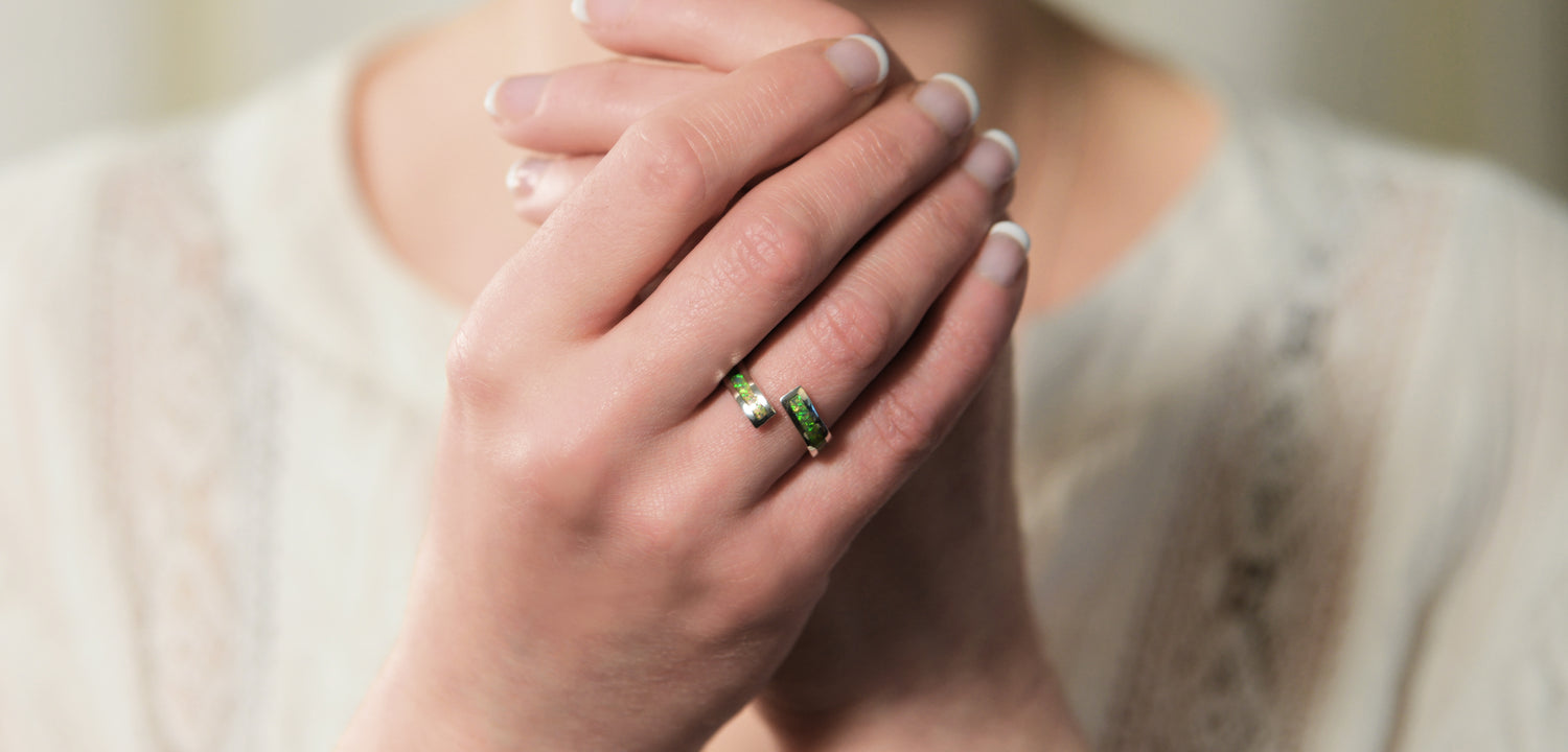 Opals & Ashes Spiral Memorial Ring Silver. Modelled on female hand. Ashes blended with Spring Green Opals.