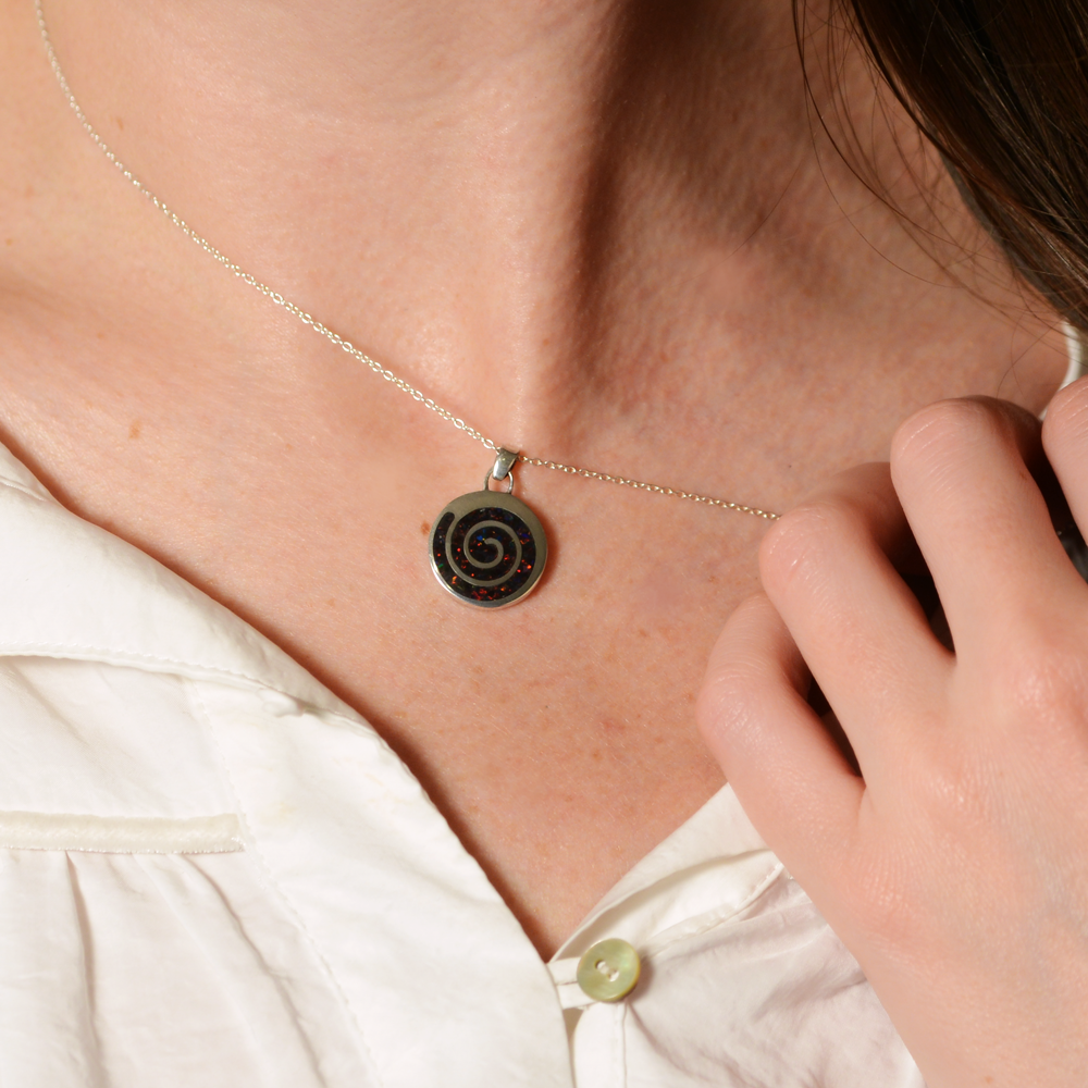 Opals & Ashes Spiral Memorial Pendant Silver. Modelled on female. Ashes blended with Black Fire Opals.