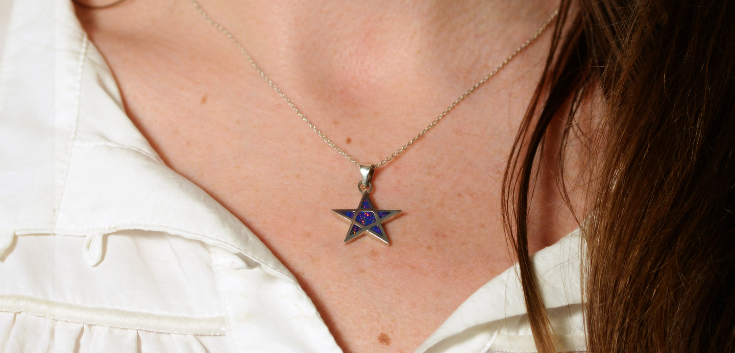 Opals & Ashes Five Star Memorial Pendant Silver. Modelled on female. Ashes blended with Royal Blue Opals.