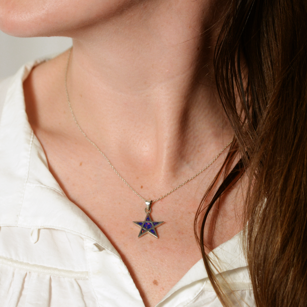 Opals & Ashes Five Star Memorial Pendant Silver. Modelled on female. Ashes blended with Royal Blue Opals. Side